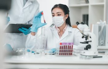 Medical research team conducting health and pharmaceutical experiments using blood samples in laboratory to develop advanced treatments and vaccines for global healthcare innovation