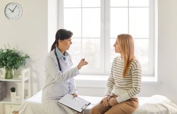Feminist health clinic, supporting caring female doctor meeting, greeting, consulting young woman patient, offering medical advice in gynecology, sexual health, fertility, menopause, helping