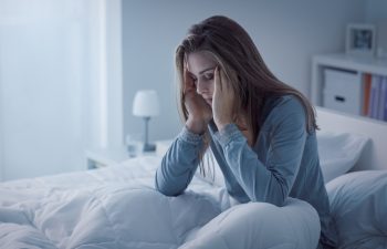 Depressed woman awake in the night, she is exhausted and suffering from insomnia