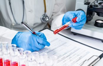 Blood test tubes. Senior female scientist examining blood test tubes at her laboratory dna testing analysis profession specialist clinician experienced medicine healthcare doctor concept copyspace