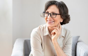 Portrait of smiling middle aged woman in glasses, copy space