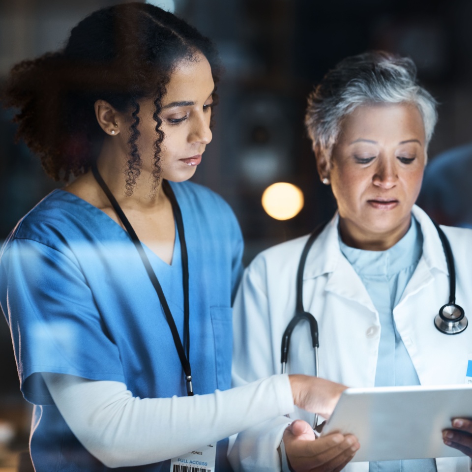Women, doctors and tablet for night medical research, surgery planning and teamwork in hospital. Nurse, healthcare and worker collaboration on technology in late shift for wellness thinking and ideas.