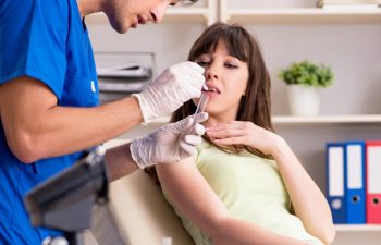 The doctor getting saliva test sample in clinic hospital