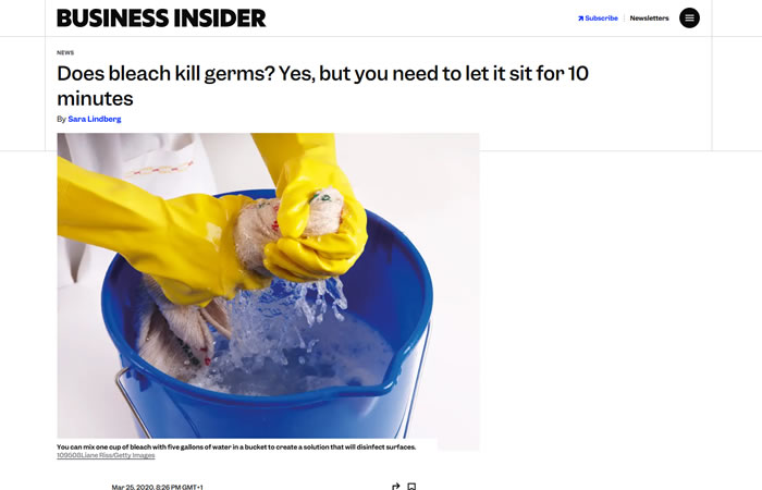 Person wearing yellow gloves cleaning a surface with a cloth in a blue bucket of water, illustrating the use of bleach for disinfecting.
