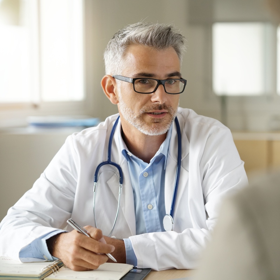 Doctor talking to patient in office