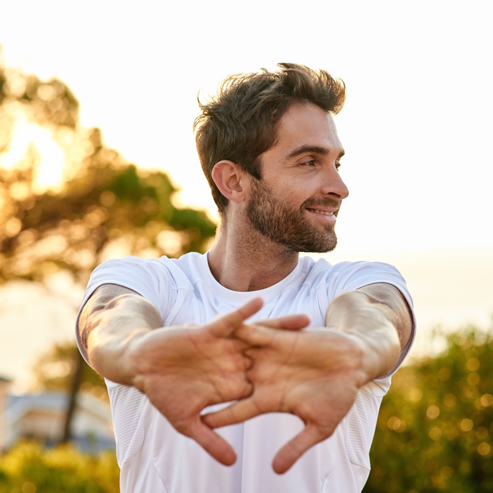 Shot of a man stretching before a run.