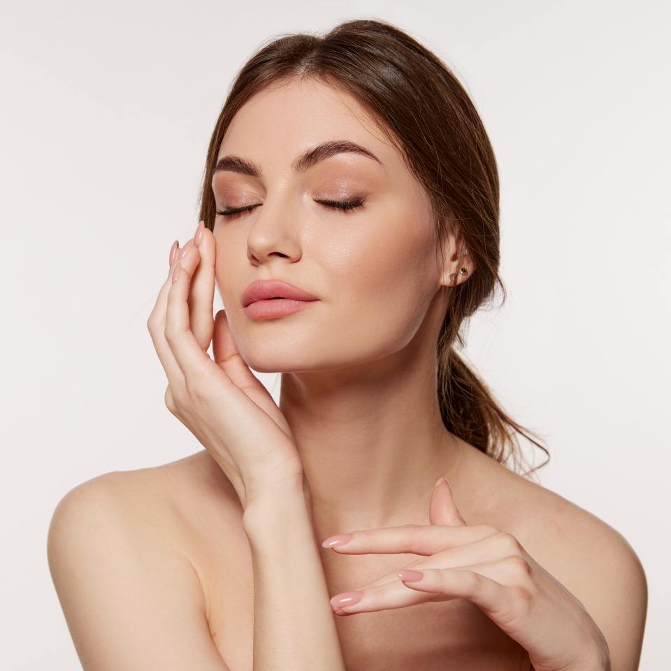 Portrait of young beautiful woman with perfect smooth skin isolated over white background. Tenderness and sensuality. Concept of natural beauty, plastic surgery, cosmetology, cosmetics, skin care